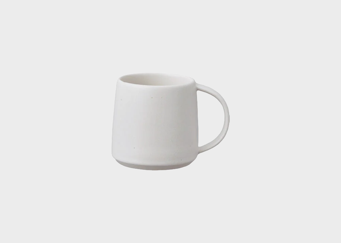 
                  
                    White ceramic mug on a light gray background
                  
                