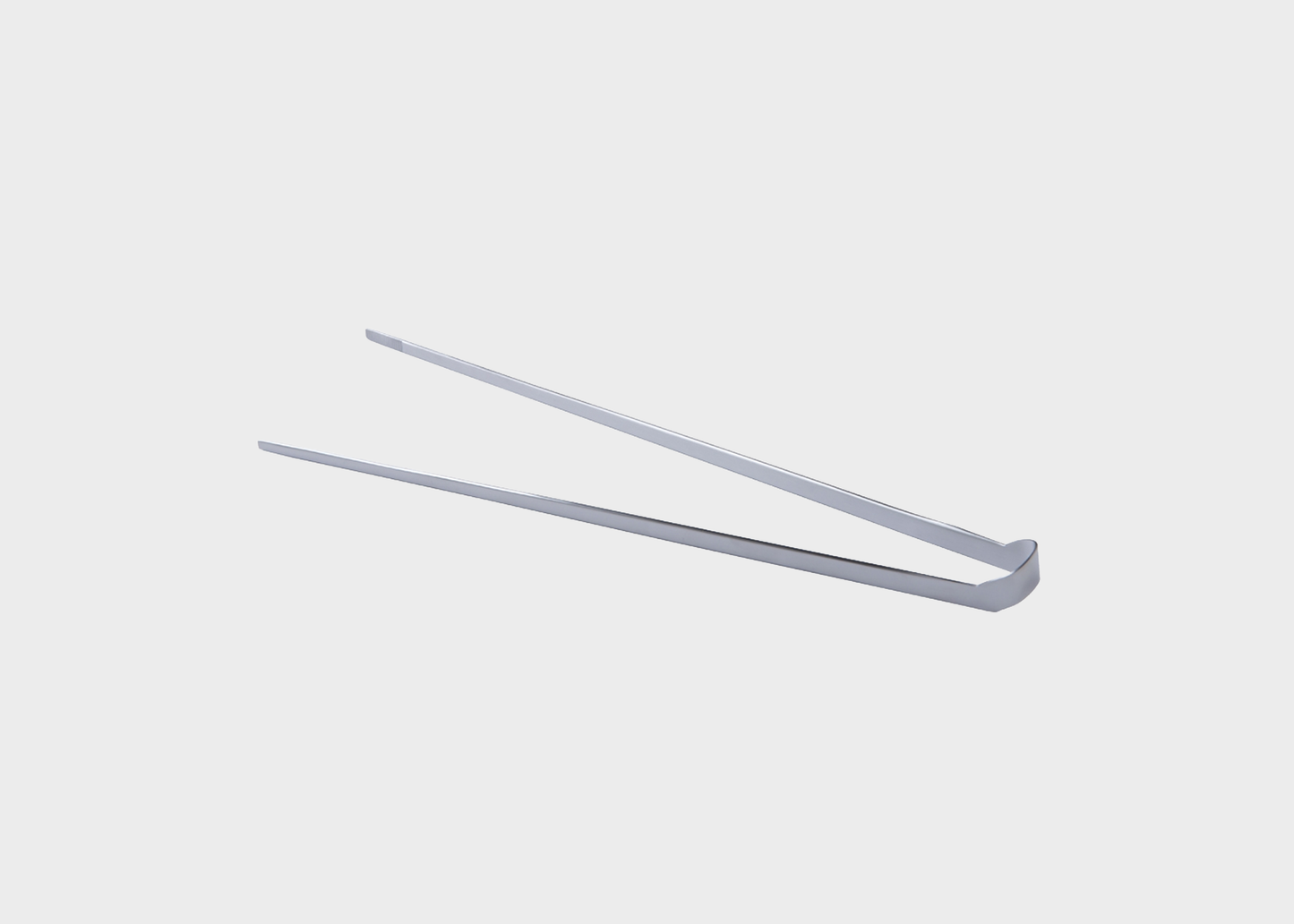
                  
                    A pair of slim, metallic silver kitchen tongs on a solid light gray background.
                  
                
