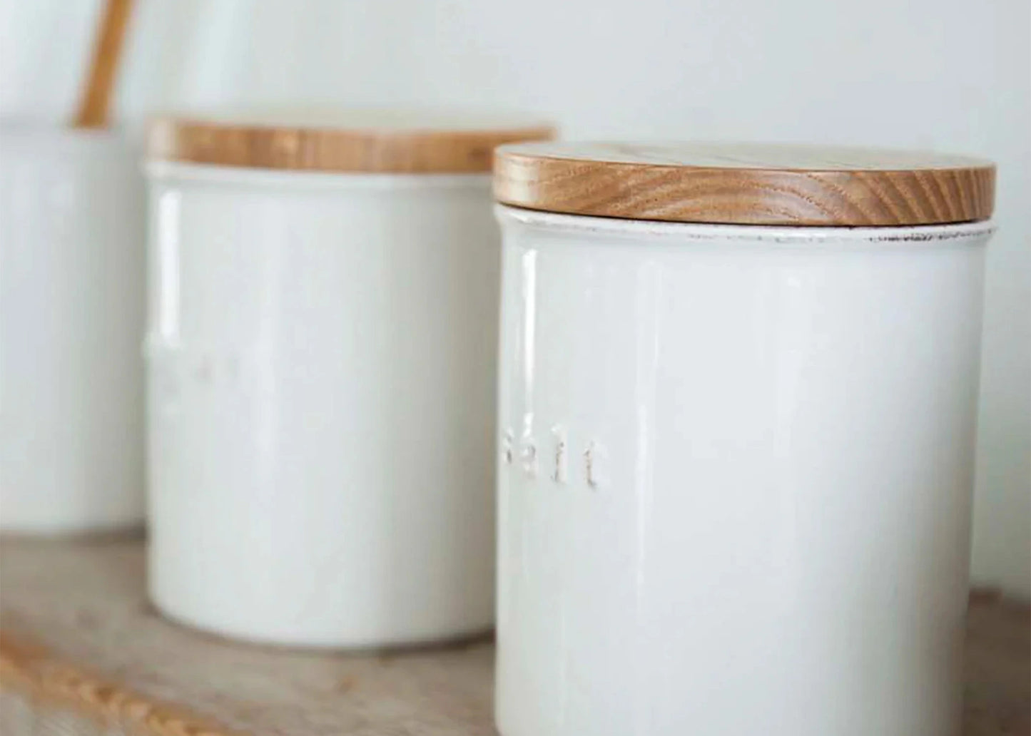 
                  
                    Ceramic Salt Canister by Yamazaki with a white ceramic base and a wooden lid.
                  
                