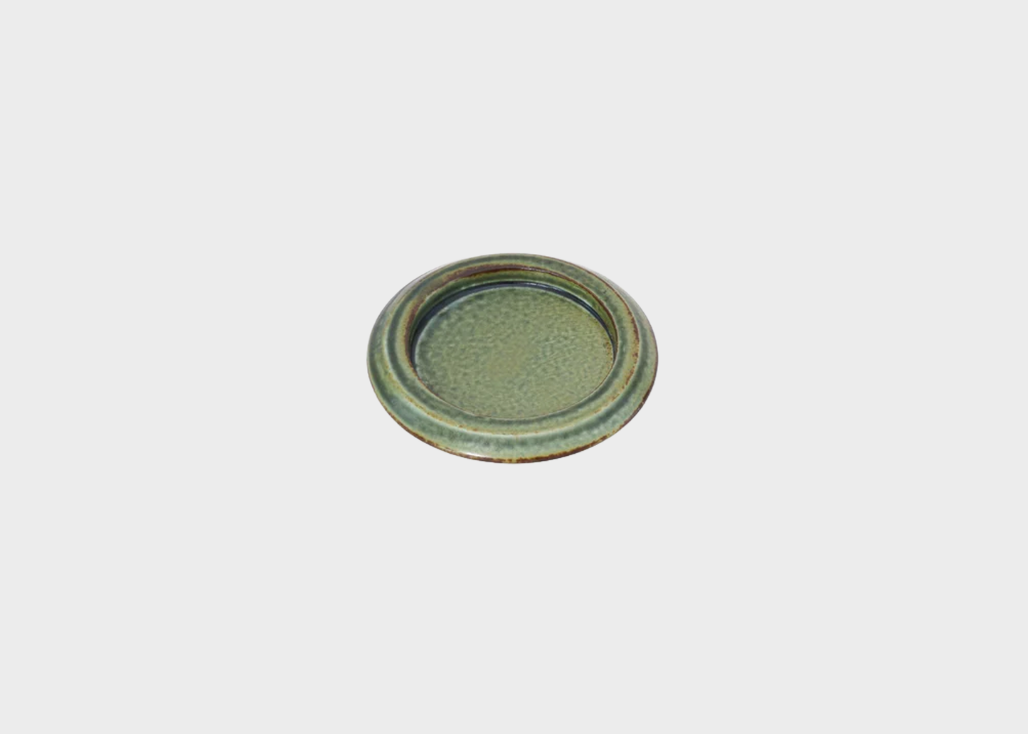 
                  
                    Round ceramic plate with greenish-brown glaze on a light gray background
                  
                