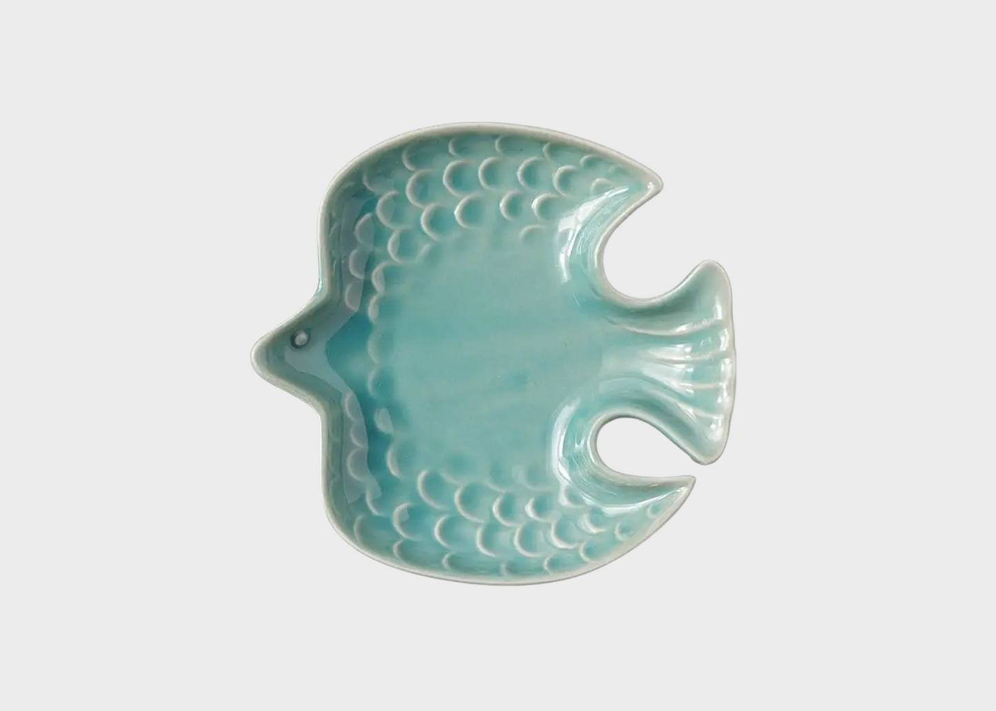 Ceramic bird-shaped dish with a textured surface on a white background