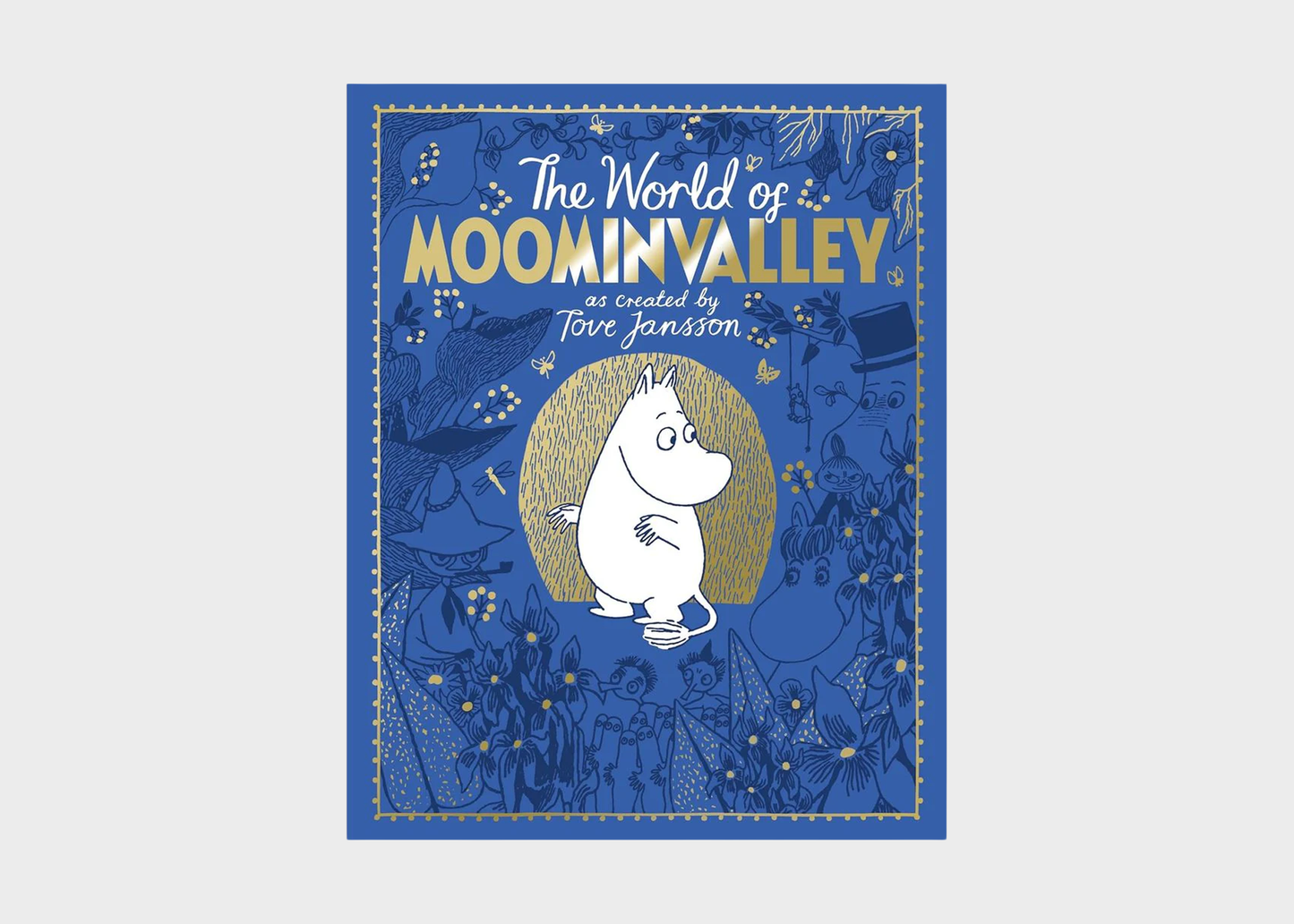 The World of Moominvalley book cover featuring a blue illustrated background with the white Moomin character in the center and gold title text, shown against a light gray background.