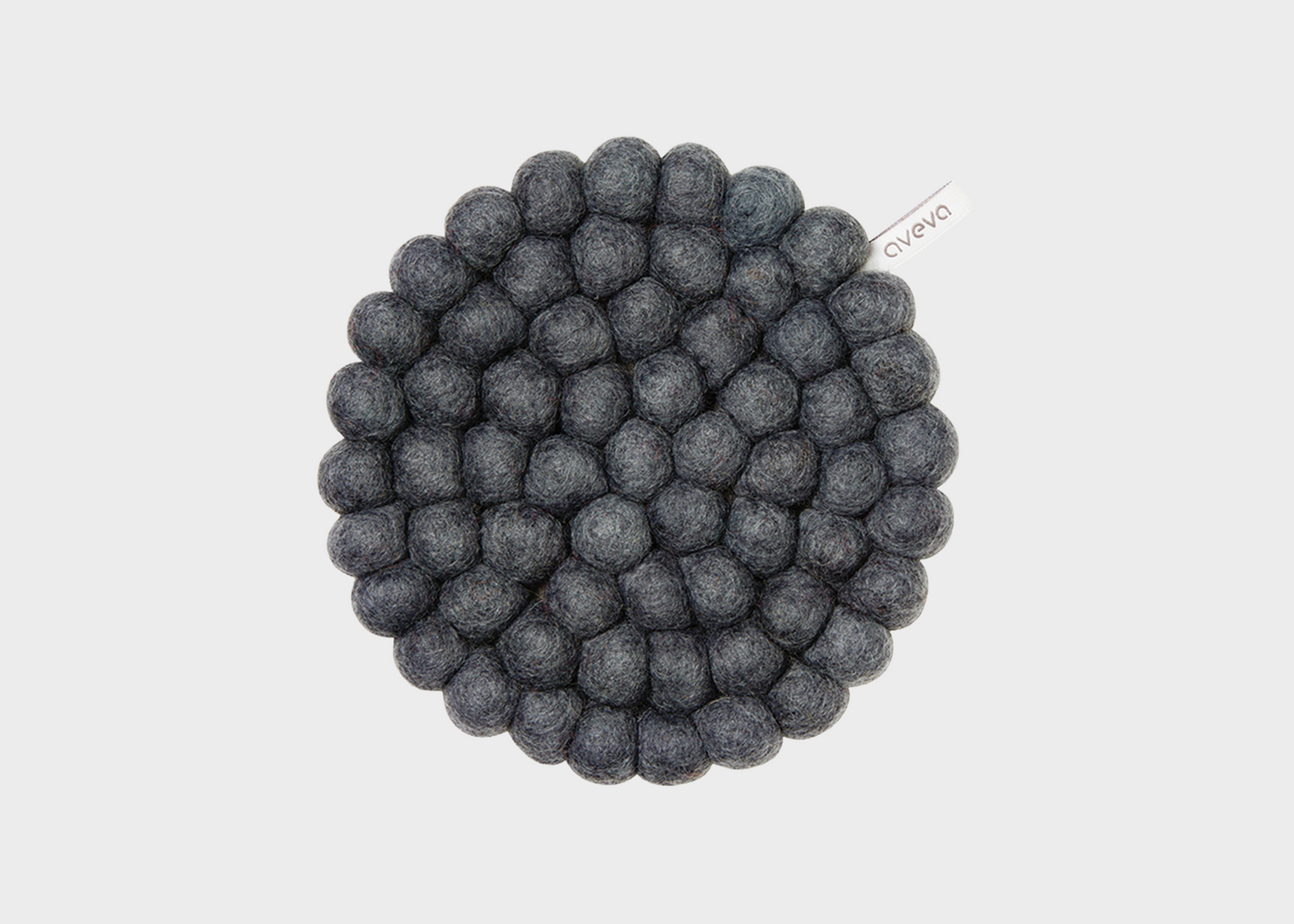 Round woven trivet with a textured surface on a light gray background