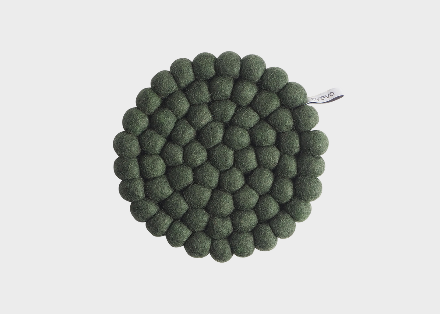 Green textured round trivet on a light gray background