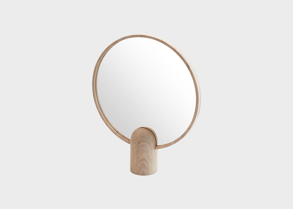 The round handheld large Aino mirror by Skagerak and Fritz Hansen