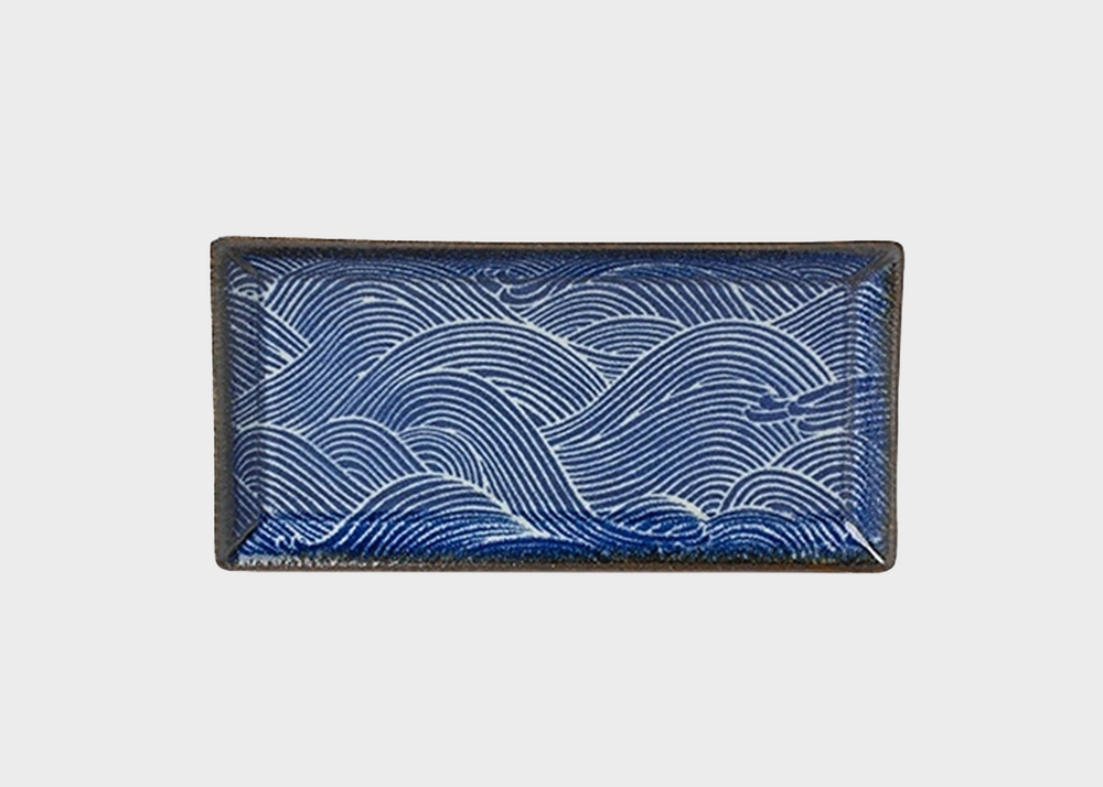 A small rectangular plate with deep blue wave patterns