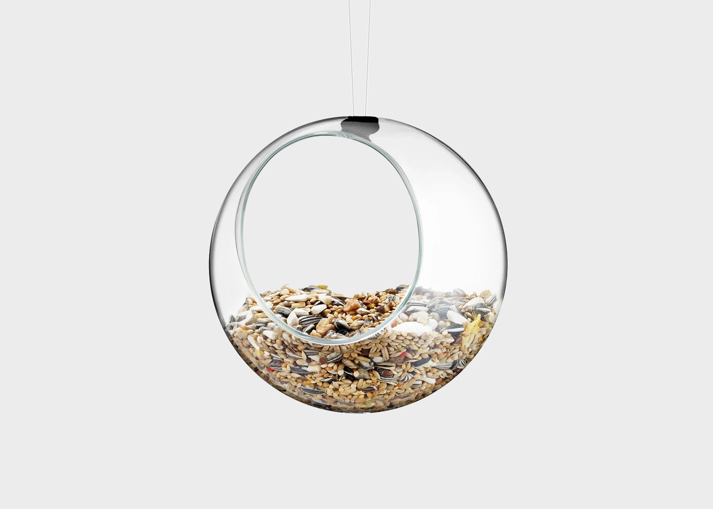 
                  
                    Eva Solo mini glass bird feeder with bird feed inside
                  
                