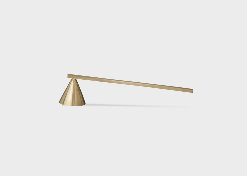 
                  
                    A brass candle extinguisher by Ferm Living with a cone extinguisher and long straight handle as sold by Woodland Mod
                  
                