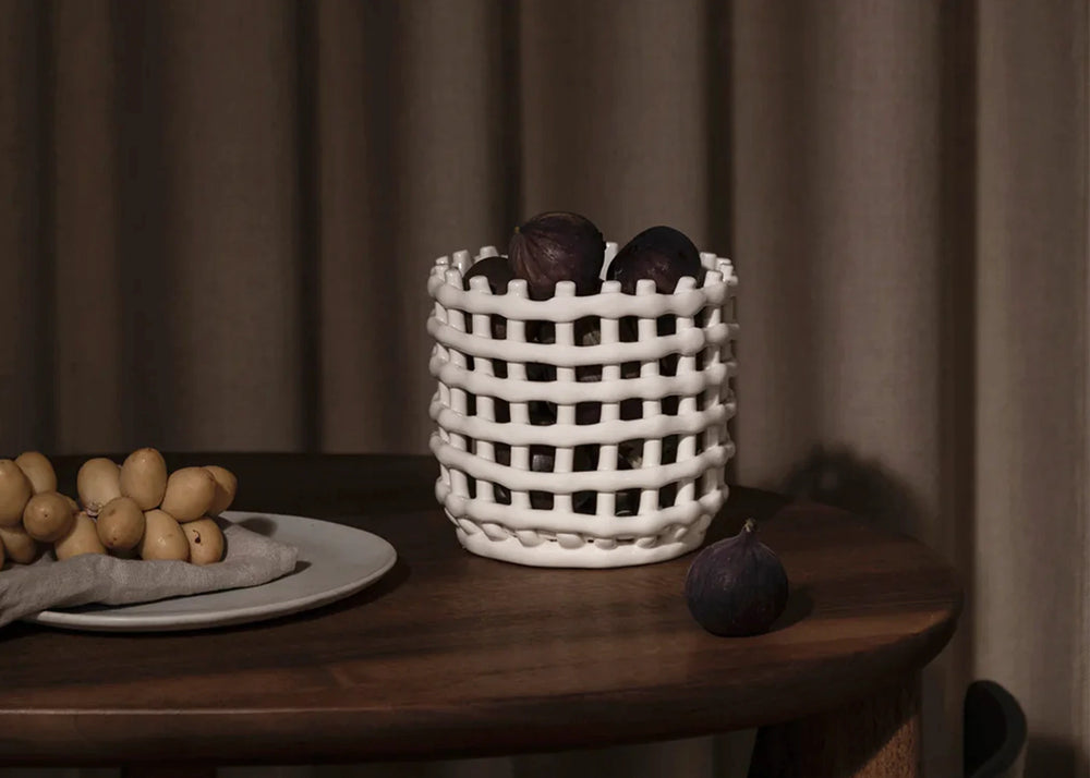 
                  
                    Ceramic Basket Off-White (Small) by Ferm Living on a table
                  
                