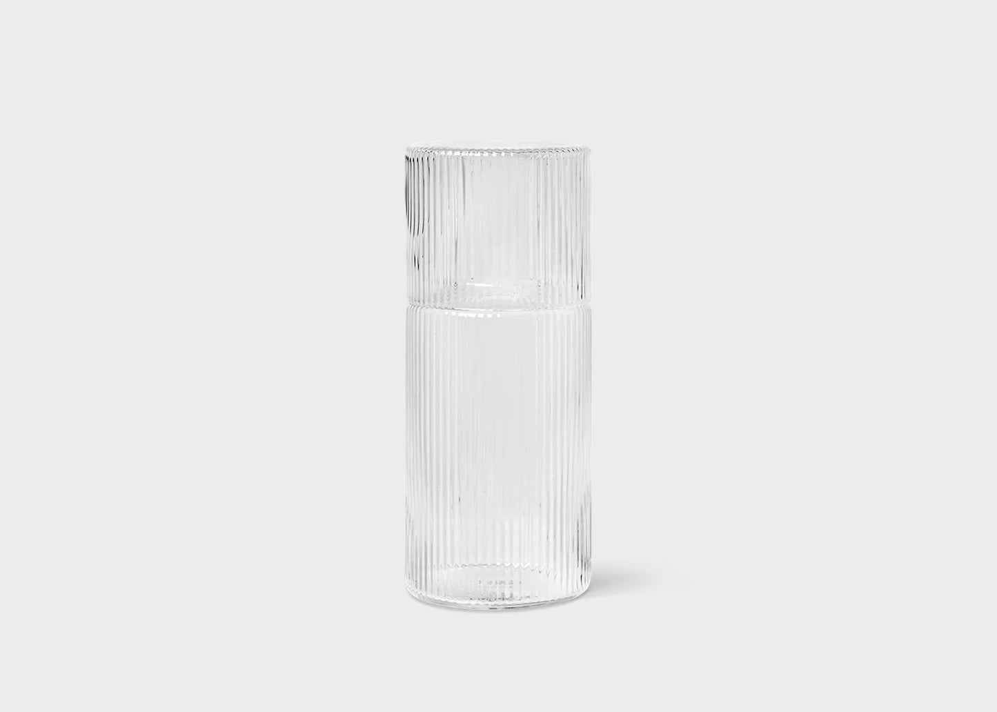 The small glass clear ripple carafe by Ferm Living with the lid on.