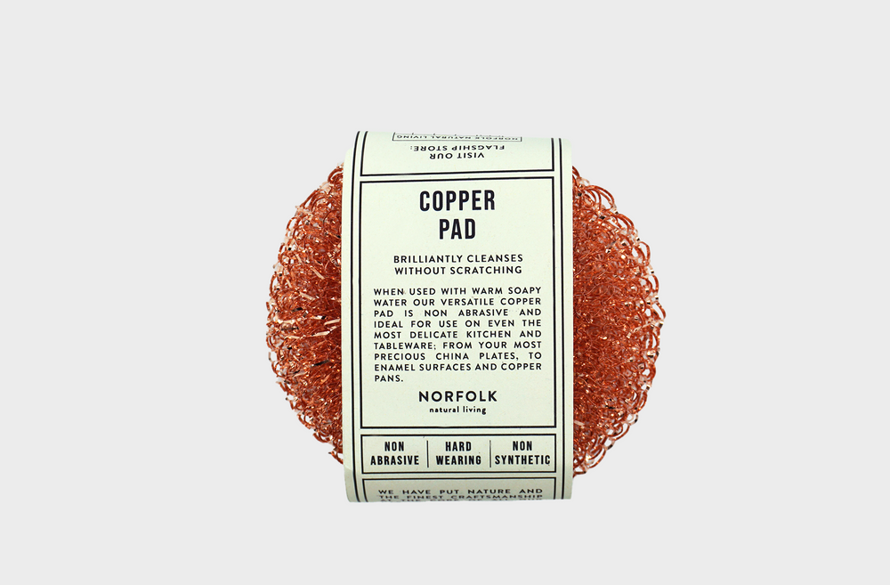 
                  
                    Coral colored copper cleaning pad with label
                  
                