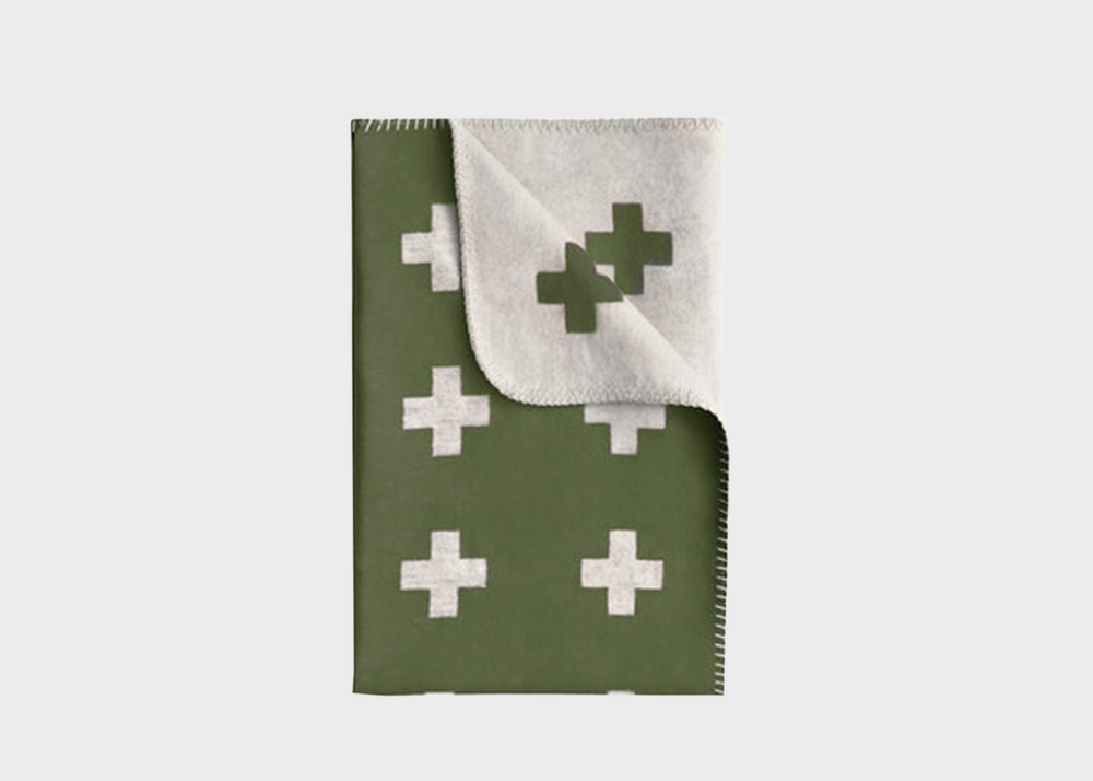 
                  
                    A dark green blanket with white crosses on it by Pia Wallen
                  
                