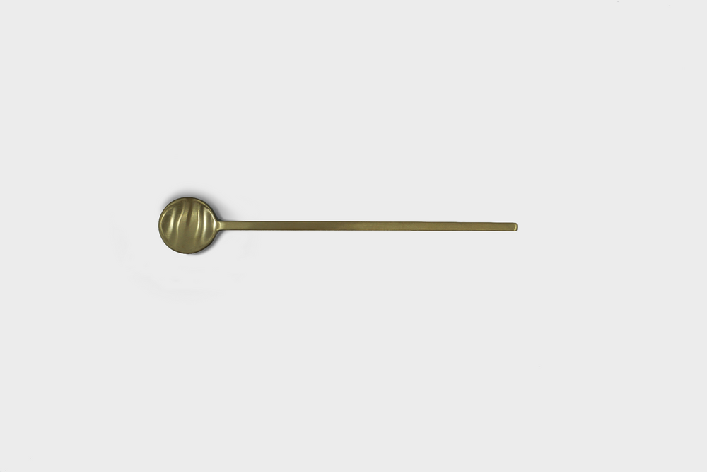 A brass Fein Long Spoon by Ferm Living