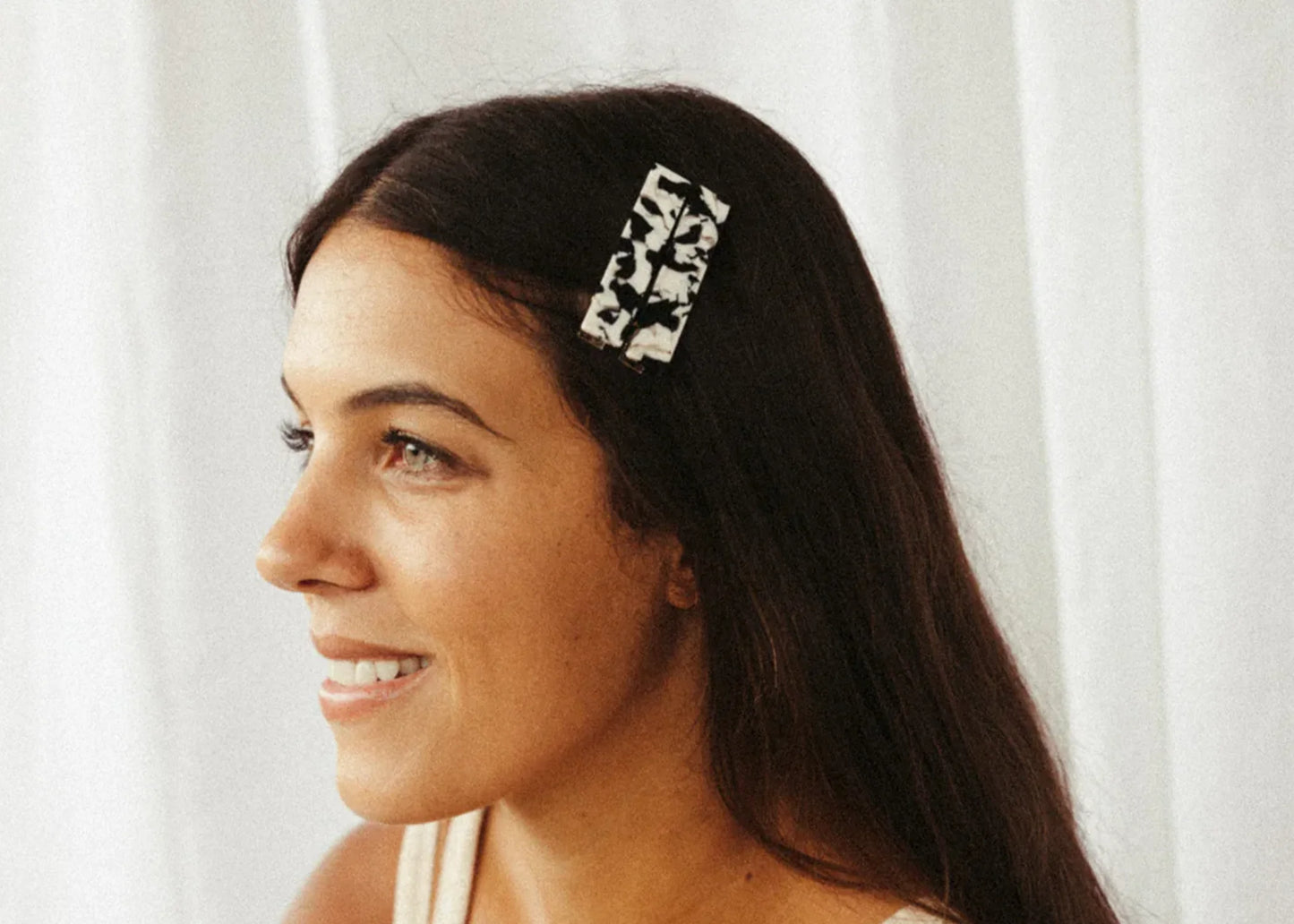 
                  
                    Woman with black and white tortoise hair clips in hair
                  
                