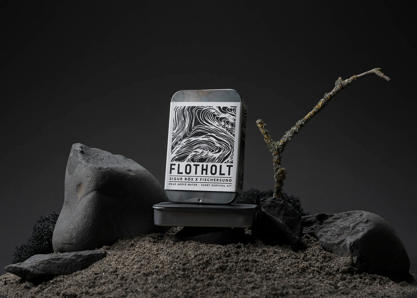 
                  
                    The Foltholt Scent Kit tin by Fischersund surrounded by dirt and rocks
                  
                