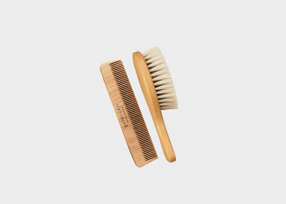 A wooden hairbrush and comb intended for toddlers and babies