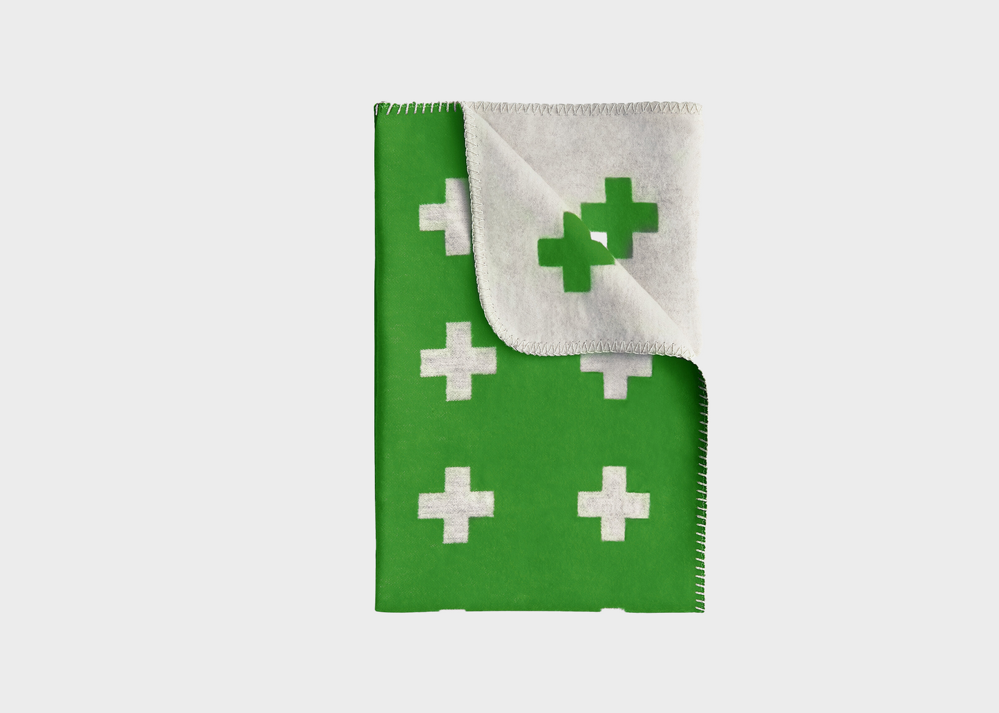 
                  
                    An green blanket with white crosses on it by Pia Wallen
                  
                