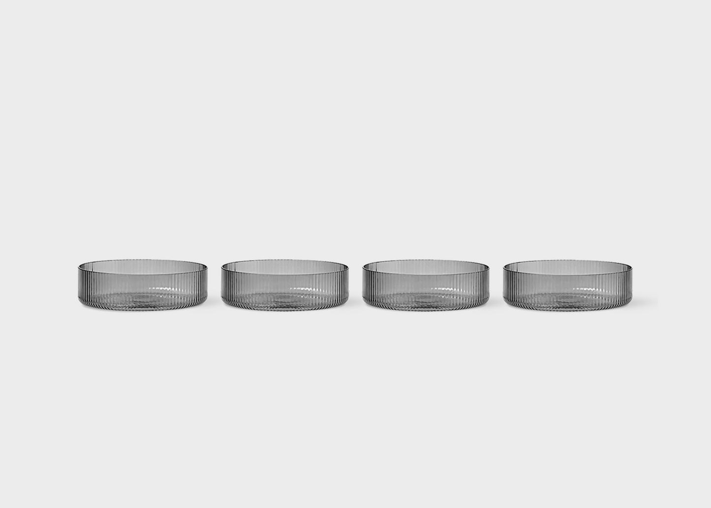 
                  
                    Smoked Grey Ripple Bowls by Ferm Living in a row
                  
                
