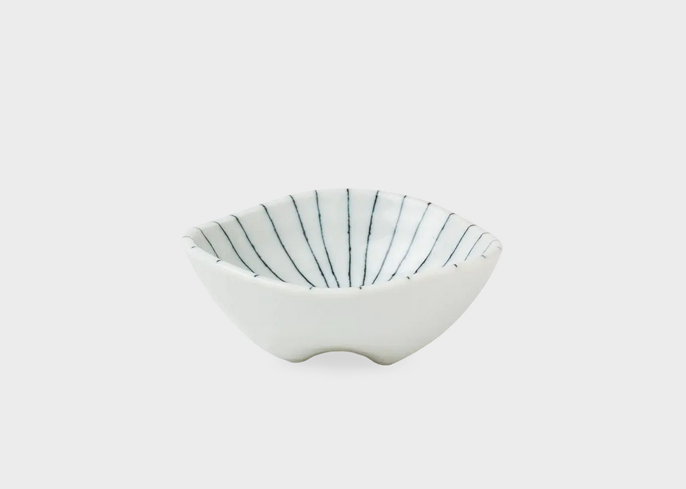 
                  
                    A small white dipping dish with dark blue thin lines decorating the inside
                  
                
