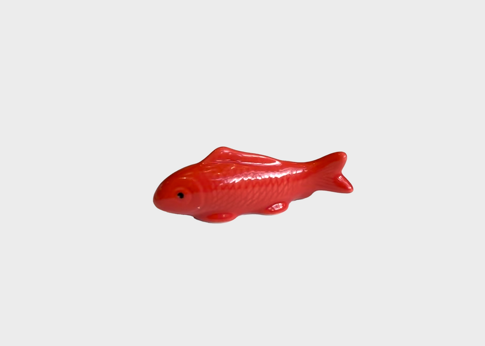 A bright red ceramic koi fish chopstick rest as sold by Woodland Mod