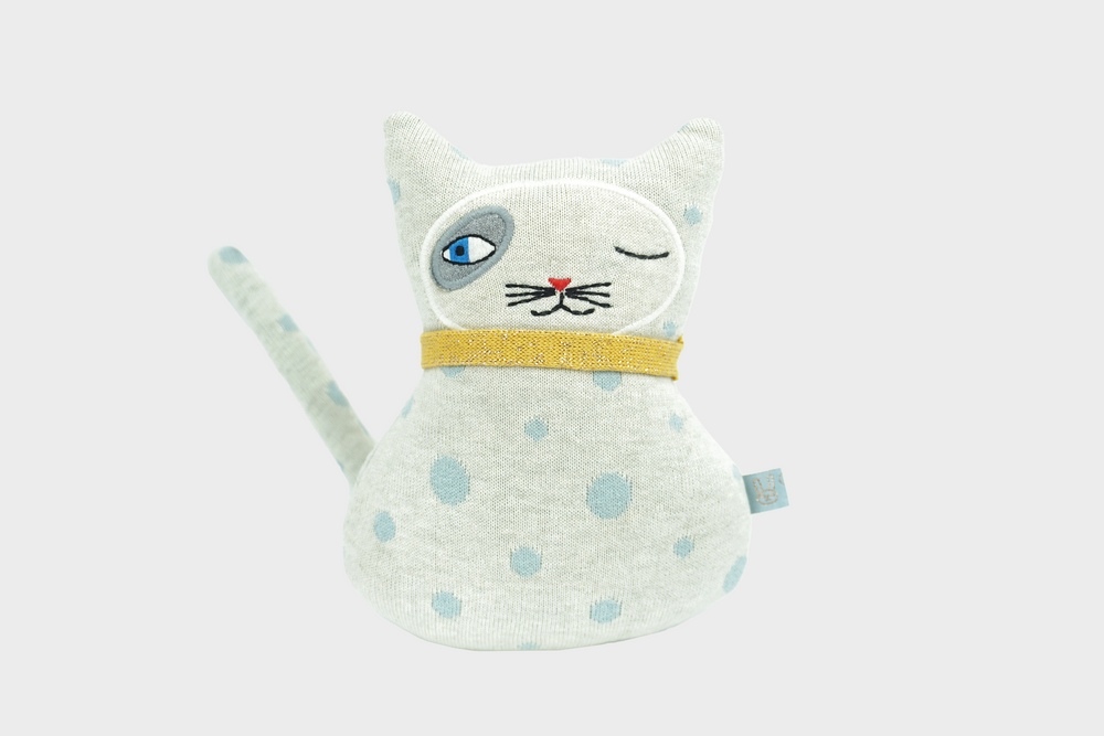 Small polka dotted white cat stuffed animal with yellow collar  