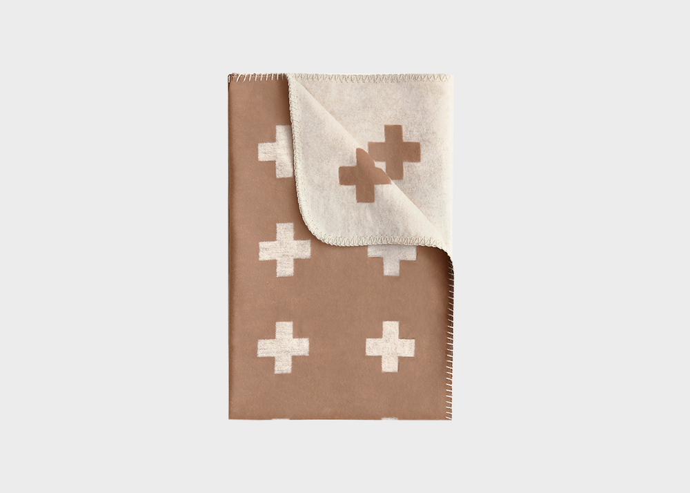 
                  
                    A camel colored blanket with white crosses on it by Pia Wallen
                  
                