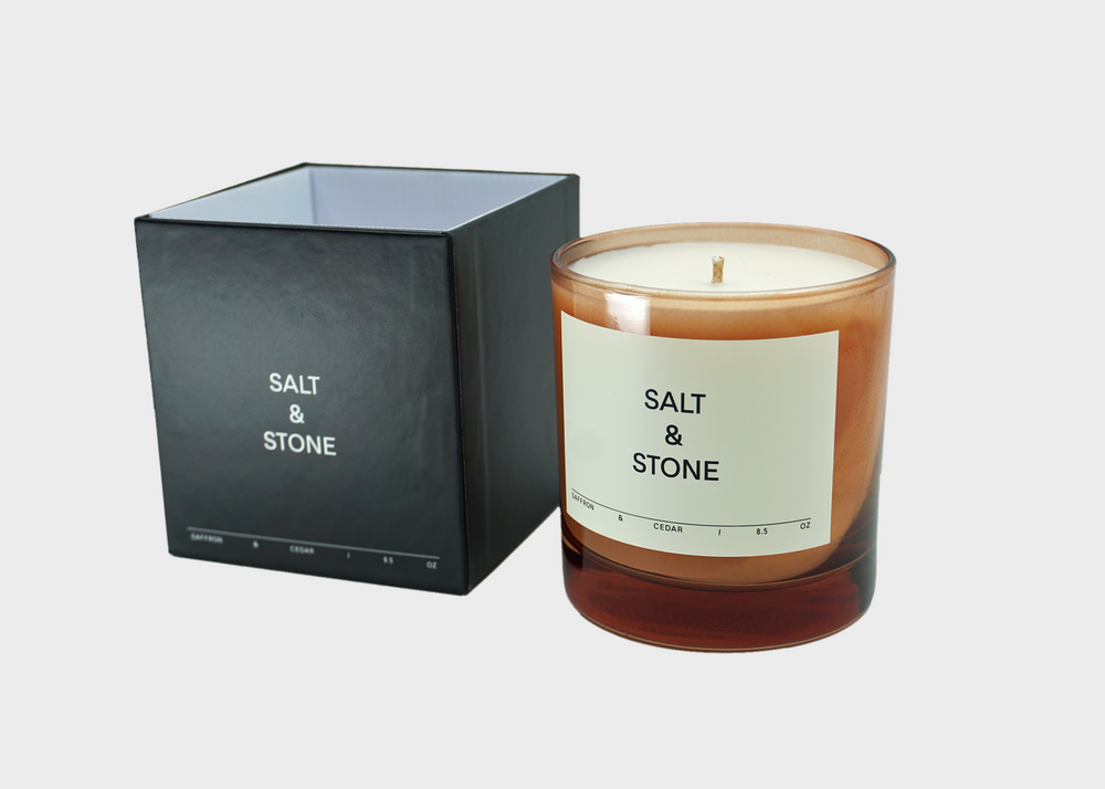 
                  
                    Saffron & Cedar Candle by Salt and Stone with pink glass and black box
                  
                