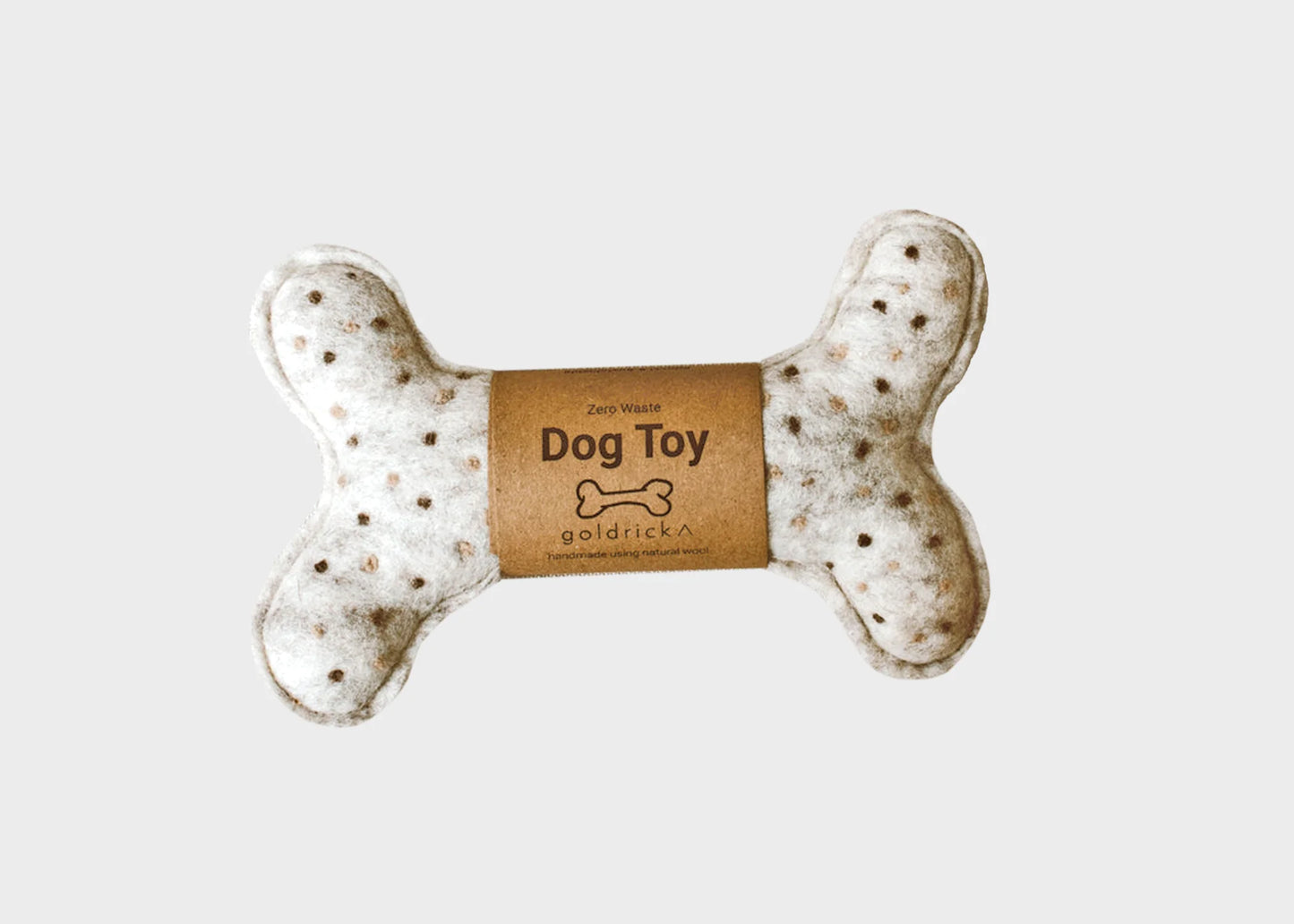 A Zero Waste Dog Toy by Goldrick in a bone shape made of natural wool with packaging.