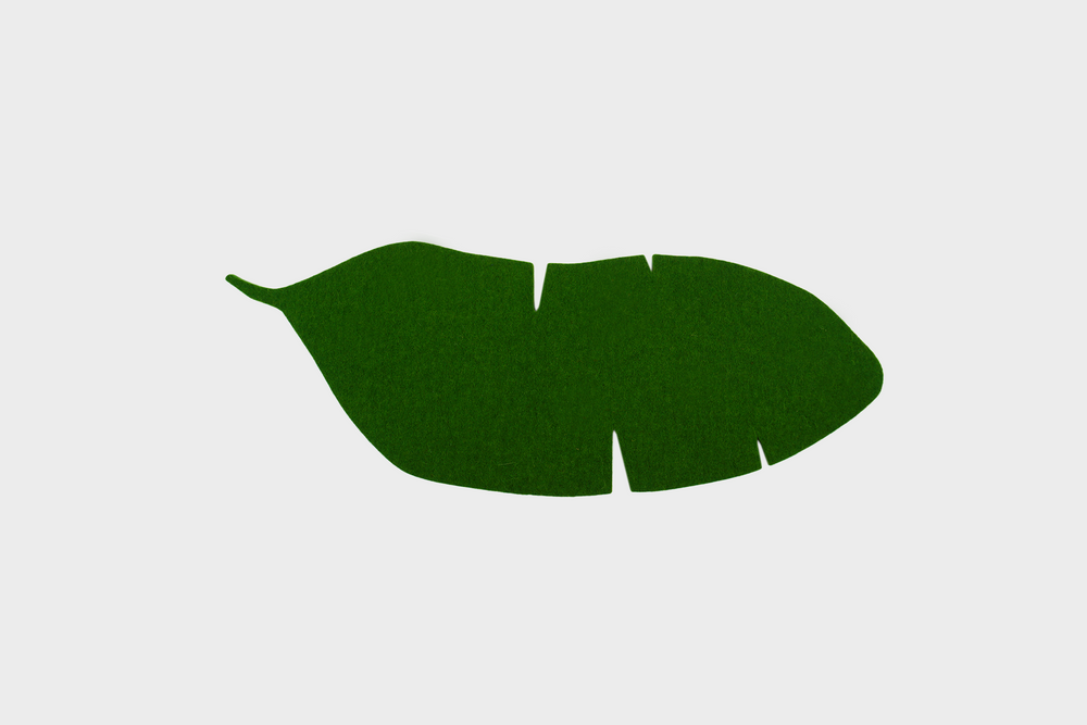 A felt trivet shaped as a banana leaf