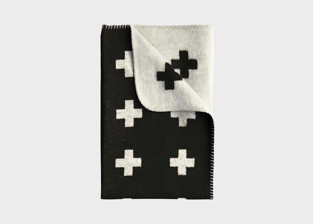 A black blanket with white crosses on it by Pia Wallen