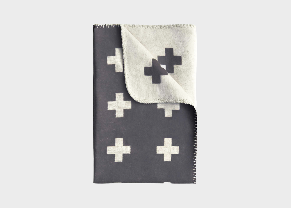 
                  
                    A grey blanket with white crosses on it by Pia Wallen
                  
                
