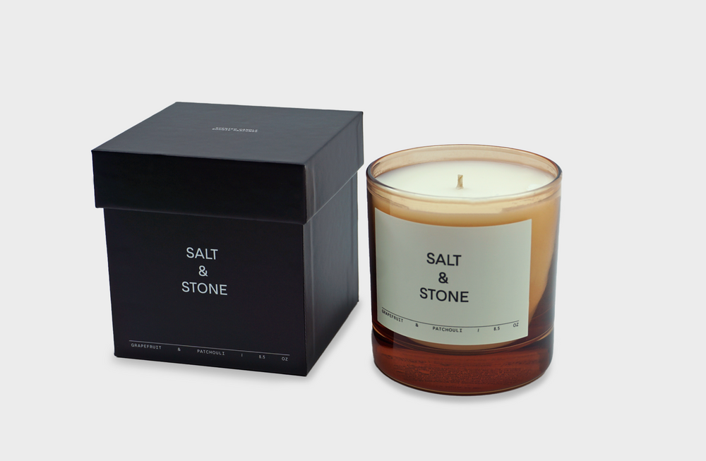 
                  
                    Grapefruit & Patchouli Candle by Salt and Stone with pink glass and black box
                  
                